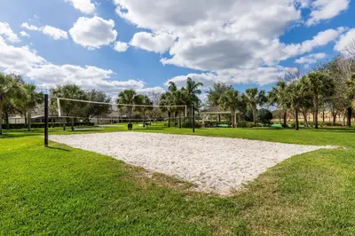 a volleyball court in a park with palm trees at Budget Friendly Condo in Windsor Hills Resort w garden view in Orlando
