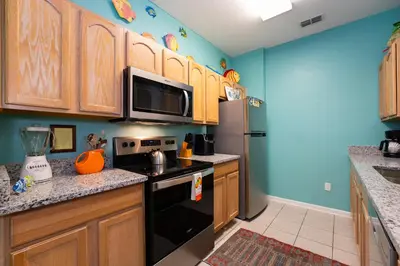 a kitchen with a stove and a refrigerator at Budget Friendly Condo in Windsor Hills Resort w garden view in Orlando