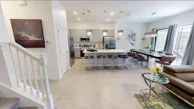 a living room with a kitchen and a dining room at Paradiso Grande 8BD Games Themed Rooms & Pool Spa in Orlando
