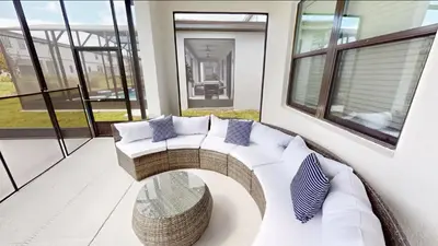 a living room with a white couch and a table at Paradiso Grande 8BD Games Themed Rooms & Pool Spa in Orlando
