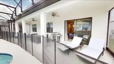 a balcony with white chairs and a swimming pool at Paradiso Grande 8BD Games Themed Rooms & Pool Spa in Orlando