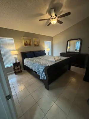 a bedroom with a bed and a ceiling fan at Minnie Heaven in Kissimmee