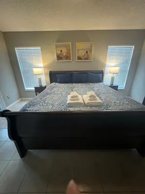 a bedroom with a bed with two towels on it at Minnie Heaven in Kissimmee
