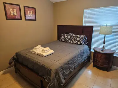 a bedroom with a bed with two towels on it at Minnie Heaven in Kissimmee