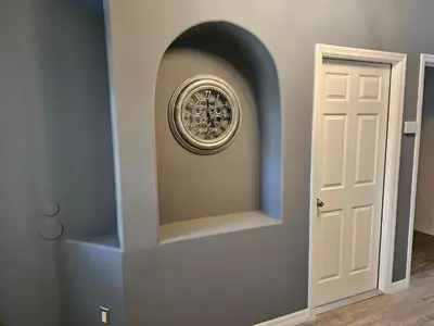 a hallway with a door and a wall with a mirror at Mufasa's Pride in Kissimmee
