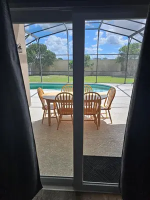 a view of a table and chairs through a window at Mufasa's Pride in Kissimmee