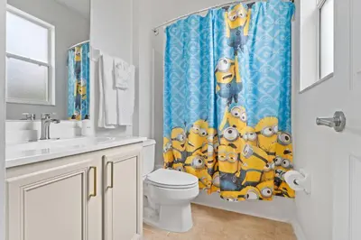 a bathroom with a toilet and a shower curtain at EPIC Theme 9D 360 Rotating Virtual Reality Machine 4 mi to Disney in Kissimmee