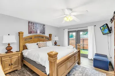 a bedroom with a bed and a ceiling fan at Tranquil Oasis 4BR Pool Home in Orlando