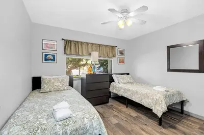a bedroom with two beds and a ceiling fan at Tranquil Oasis 4BR Pool Home in Orlando