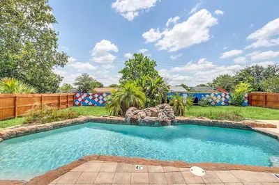 a swimming pool in a yard with a fence at Tranquil Oasis 4BR Pool Home in Orlando