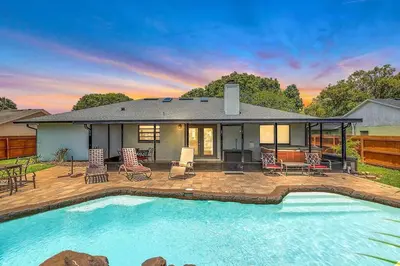 a house with a swimming pool in front of a house at Tranquil Oasis 4BR Pool Home in Orlando