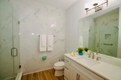 a bathroom with a toilet and a sink and a shower at Vista Cay at Epic Universe - Luxury 4 bedroom Condo in Orlando
