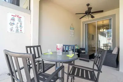 a dining room table with four chairs and a ceiling fan at Stunning 5Bd with Pool at Storey Lake 5019 in Kissimmee