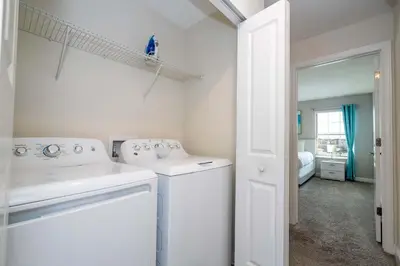 a white laundry room with a washer and dryer at Stunning 5Bd with Pool at Storey Lake 5019 in Kissimmee