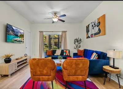 a living room with a blue couch and two chairs at Disney Paradise-Family Friendly- Near to Disney in Orlando