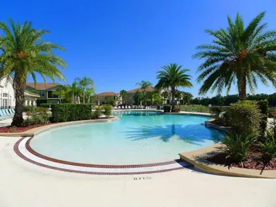 a large swimming pool with palm trees in a resort at Disney Paradise-Family Friendly- Near to Disney in Orlando