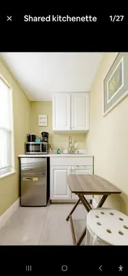 a kitchen with a stove and a table in it at Pretige Studio in Orlando