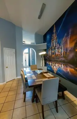 a dining room with a table and a castle mural at Disney World Vacation Home in Orlando