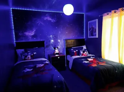 a purple bedroom with two beds with dolls on them at Amazing Star Wars & Disney Vr Gaming House! in Kissimmee