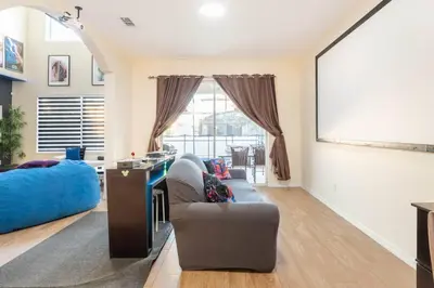 a living room with a couch and a large window at Amazing Star Wars & Disney Vr Gaming House! in Kissimmee