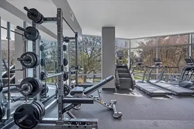 a gym with several treadmills and machines at Stunning & Luxurious 2Bed 2Bath Open floor plan in Orlando