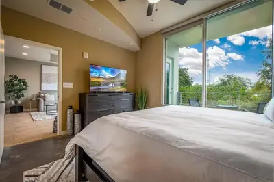 a large bedroom with a large bed and a large window at Stunning & Luxurious 2Bed 2Bath Open floor plan in Orlando