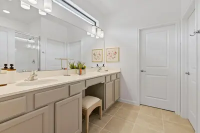 a bathroom with two sinks and a large mirror at Brand NEW 12Bed12Bath At Paradiso Grande in Orlando