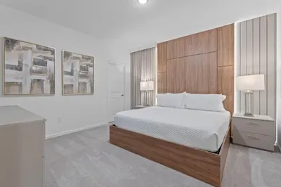 a bedroom with a large bed and two lamps at Brand NEW 12Bed12Bath At Paradiso Grande in Orlando