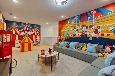 a living room with a couch and a circus mural at Brand NEW 12Bed12Bath At Paradiso Grande in Orlando
