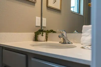 a bathroom sink with a faucet and a mirror at Brand NEW 12Bed12Bath At Paradiso Grande in Orlando