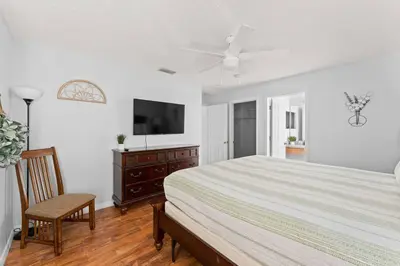 a bedroom with a bed and a flat screen tv at 7BR Family Friendly Resort Pool Home Near Disney World in Kissimmee
