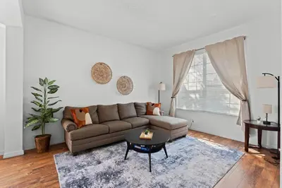 a living room with a couch and a table at 7BR Family Friendly Resort Pool Home Near Disney World in Kissimmee