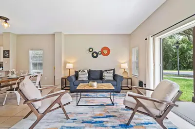 a living room with a couch and chairs at 8400 Blue Lagoon Drive in Kissimmee