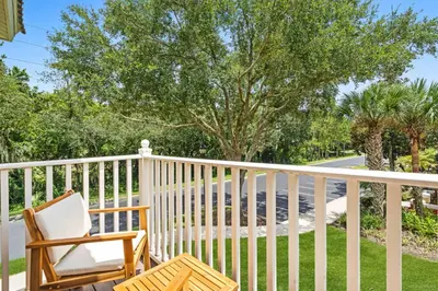 a porch with two chairs and a tree at 8400 Blue Lagoon Drive in Kissimmee