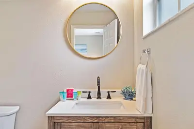 a bathroom with a sink and a mirror at 8400 Blue Lagoon Drive in Kissimmee
