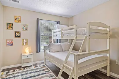 a bedroom with two bunk beds and a window at 8400 Blue Lagoon Drive in Kissimmee