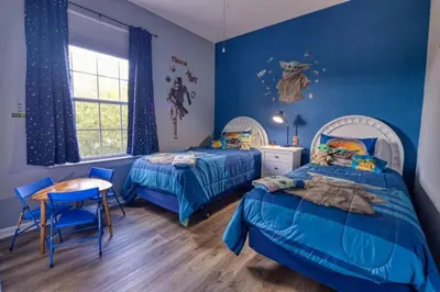 a bedroom with two beds and a table and chairs at Amazing Condo in Windsor Hills Close to Disney in Orlando