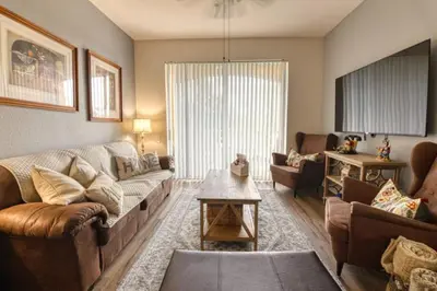 a living room with a couch and a table at Amazing Condo in Windsor Hills Close to Disney in Orlando