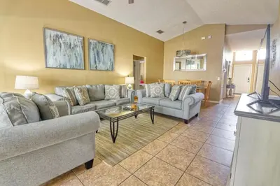 a living room with two couches and a table at 9 Miles to Disney - Family Friendly - Private Pool in Orlando