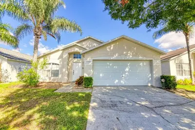 a large white house with a garage at 9 Miles to Disney - Family Friendly - Private Pool in Orlando