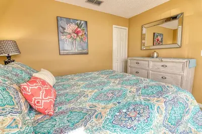 a bedroom with a bed and a dresser and a mirror at 9 Miles to Disney - Family Friendly - Private Pool in Orlando