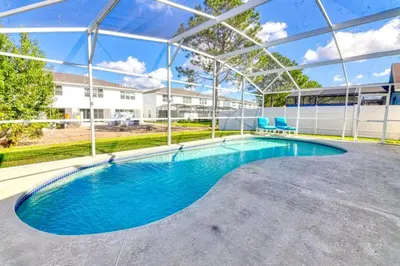 an empty swimming pool in a building with a clear roof at 9 Miles to Disney - Family Friendly - Private Pool in Orlando