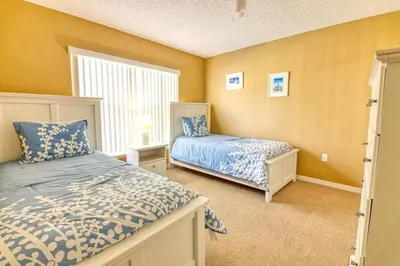 a bedroom with two beds and a window at 9 Miles to Disney - Family Friendly - Private Pool in Orlando