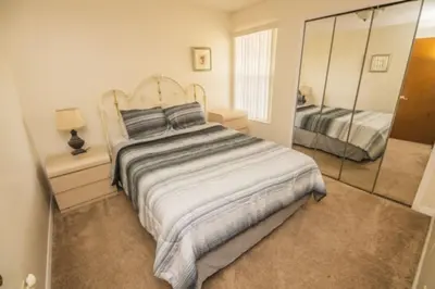 a bedroom with a large bed and a mirror at CM3 SW030-2F in Kissimmee