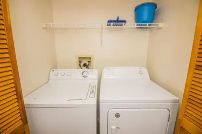 a kitchen with a stove and a washer and dryer at CM3 SW030-2F in Kissimmee