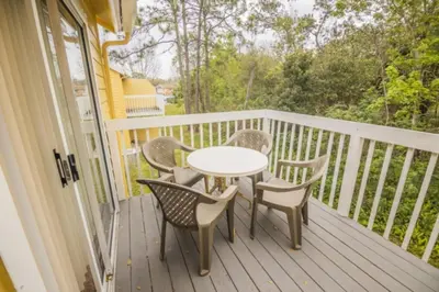 a porch with a table and chairs on a balcony at CM3 SW030-2F in Kissimmee