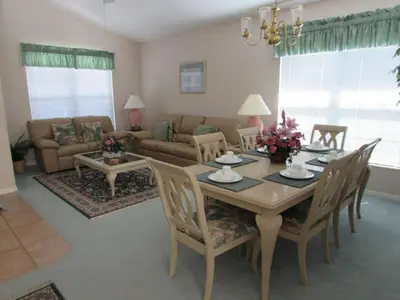 a living room with a table and a couch at Creekside Kissimmee in Kissimmee