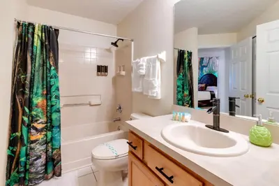 a bathroom with a sink and a toilet and a shower at VR Jungle 2 Jungle with Disney's Tarzan and MORE in Kissimmee