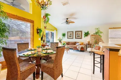a dining room and living room with a table and chairs at VR Jungle 2 Jungle with Disney's Tarzan and MORE in Kissimmee