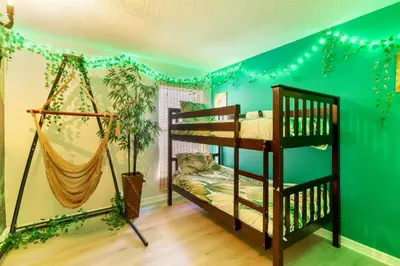 a room with two bunk beds and a hammock at VR Jungle 2 Jungle with Disney's Tarzan and MORE in Kissimmee
